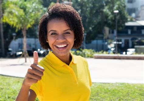 Joyful Laughing African American Woman Showing Thumb Up Stock Photo