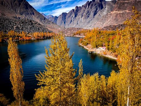 A Body Of Water Surrounded By Mountains And Trees Photo Free Skardu