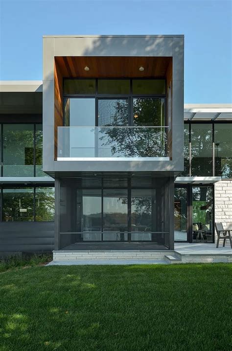 Glass Lake House Features Modern Silhouette Of Earthy