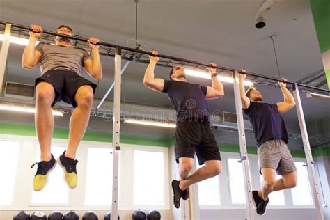 Group Of Young Men Doing Pull Ups In Gym Stock Photo Image Of