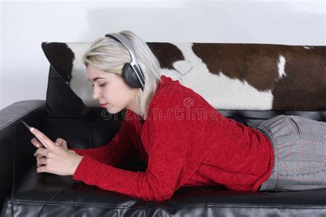 Pretty Young Woman Lying On The Couch And Texting With Her Smartphone Stock Image Image Of