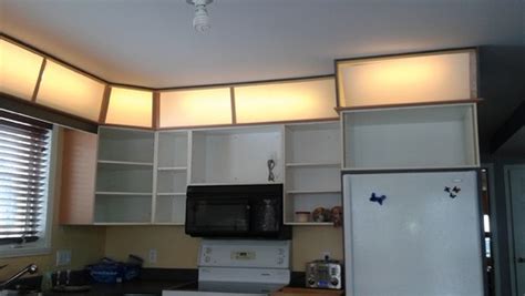 Go for a purely decorative collection of baskets. Lighting above kitchen cabinets