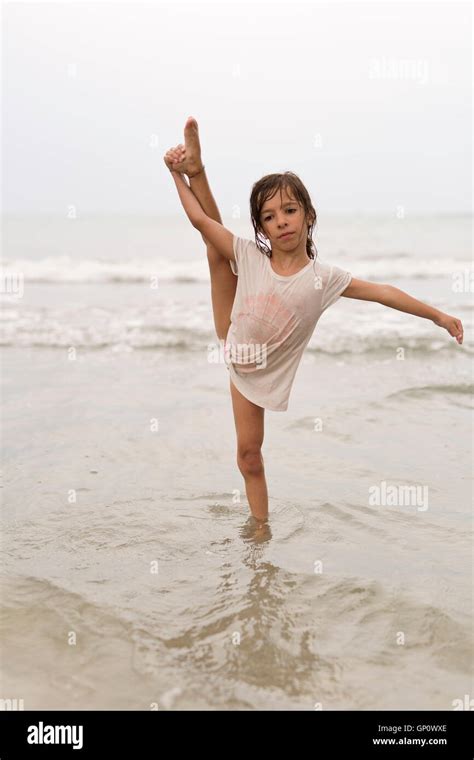 Little Girl On A Beach Doing Water Gymnastics Stock Photo Alamy