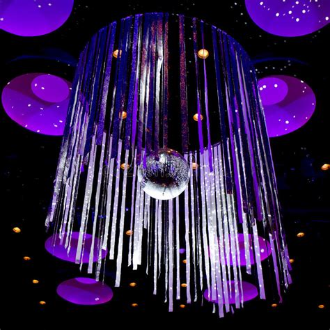 A disco ball (also known as a mirror ball or glitter ball) is a roughly spherical object that reflects light directed at it in many directions, producing a complex display. Disco Ball With Silver Sparkle Ribbon Background Stock ...