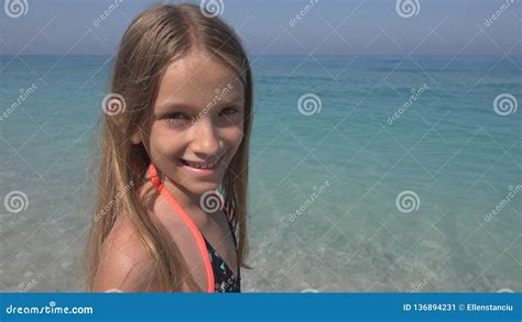 Child On Beach Happy Smiling Kid On Seashore Little Girl Laughing At