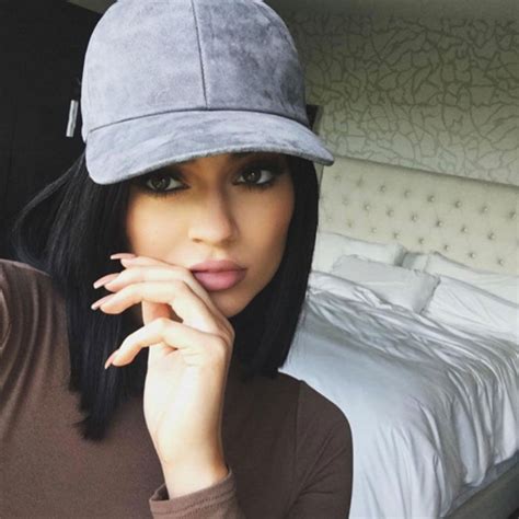 Why Kylie Jenner Always Poses With Her Fingers On Her Lips