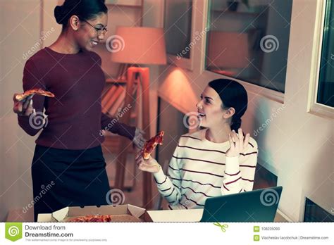 Cheerful Friends Talking To Each Other While Eating Pizza