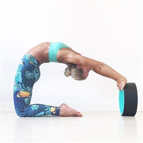 A Woman Doing A Handstand On One Leg With A Yoga Mat In Front Of Her