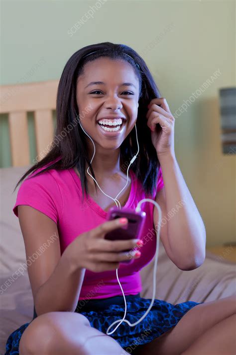 teenage girl listening to headphones stock image f005 2666 science photo library