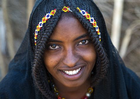 Portrait Of A Smiling Afar Tribe Girl With Braided Hair Ands Beaded