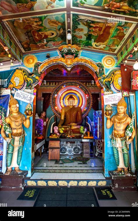 A Colourful Buddhist Shrine Featuring A Seated Buddha Statue At The