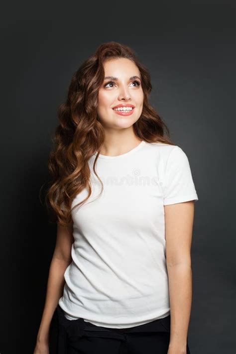 Young Beautiful Woman In White T Shirt Looking Up On Gray Background