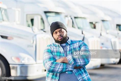 Black Man Standing In Front Of Semi Trucks Photos And Premium High Res