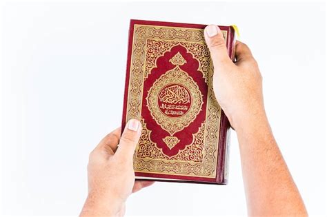 Premium Photo Koran In Hand Holy Book Of Muslims Public Item Of