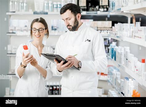 Pharmacists Checking Medication In Pharmacy Hi Res Stock Photography