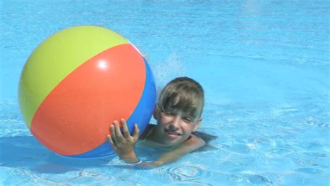 Child Playing Beach Ball In Swimming Pool Stock Footage Video 4254929