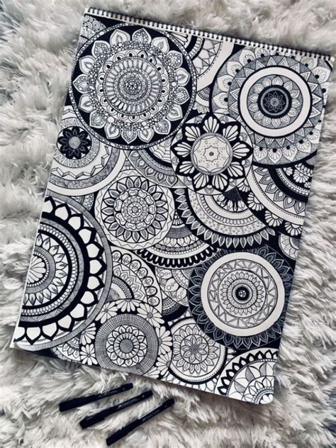 A Black And White Coloring Book Sitting On Top Of A Furry Rug Next To