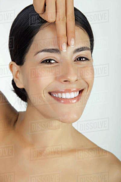 Woman Placing Fingers On Forehead Portrait Stock Photo Dissolve