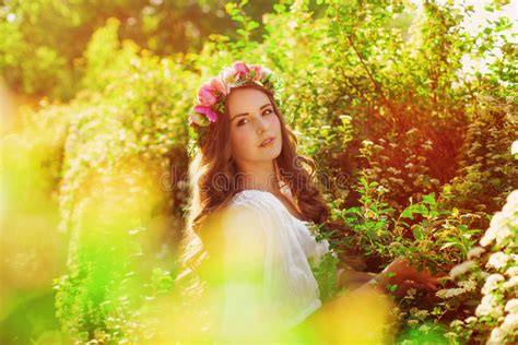 Young Beautiful Girl In A Field With Flowers In White Sundress Stock