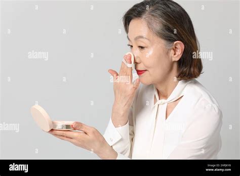 Asian Korean Senior Woman Bold And Red Cosmetics Makeup Beauty Concept In Studio Stock Photo