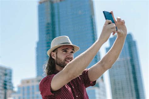 Usa New York City Man Taking A Selfie In Front Of Skyscrapers Stock Photo