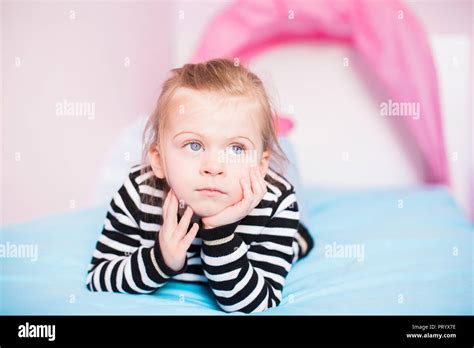 Portrait Daydreaming Little Girl Lying Bed Home Hi Res Stock