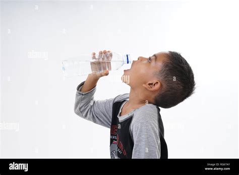 Thirsty Boy Drinking Mineral Water Stock Photo Alamy
