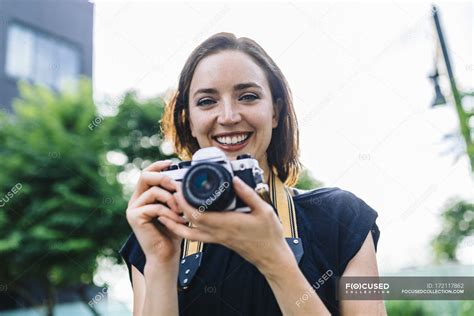 Portrait Of Smiling Woman Holding Camera — Close Up Summer Stock