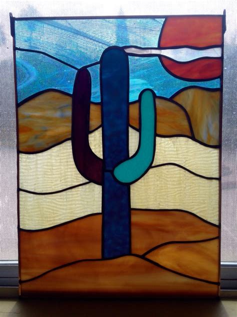 A Stained Glass Window With A Cactus In The Desert