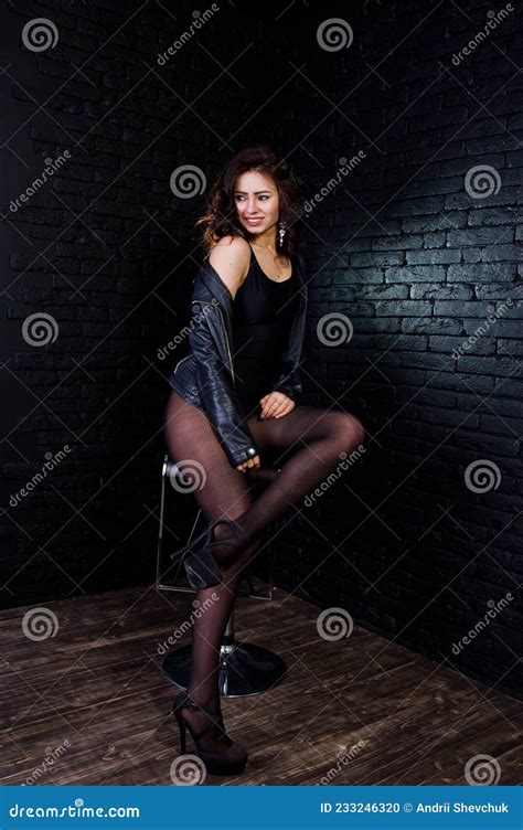 Studio Portrait Of Brunette Girl In Black Leather Jacket Stock Photo