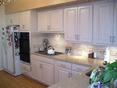 Newly Refaced White Kitchen Cabinets To Brighten Up The Home Kitchen