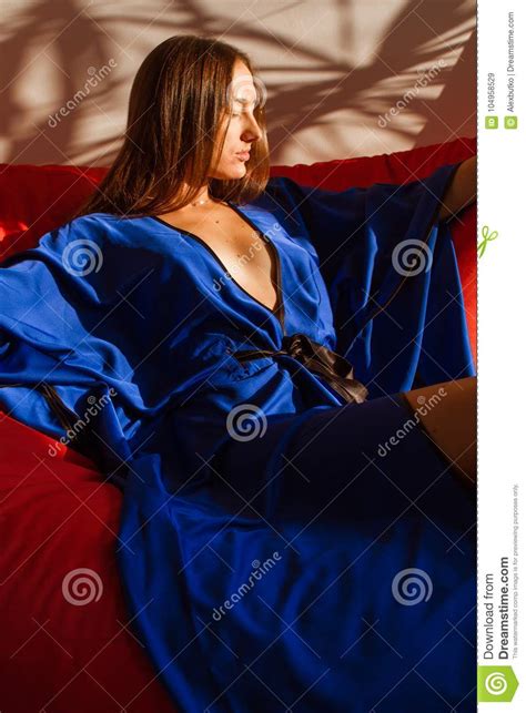 Beautiful Girl In Blue Silk Robe Resting In The Sunlight Stock Image