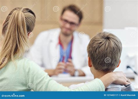 Little Boy With Mother In Clinic Having A Checkup With Pediatrician