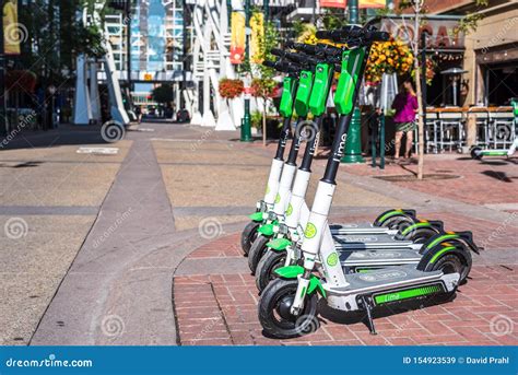 Electric Scooters Parked On Sidewalk In Calgary Editorial Stock Image