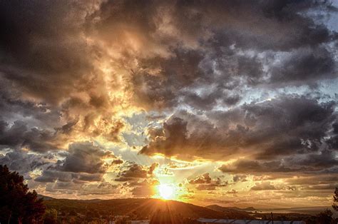 Sunrise With A Partly Cloudy Sky Photograph By Claudio Balducelli