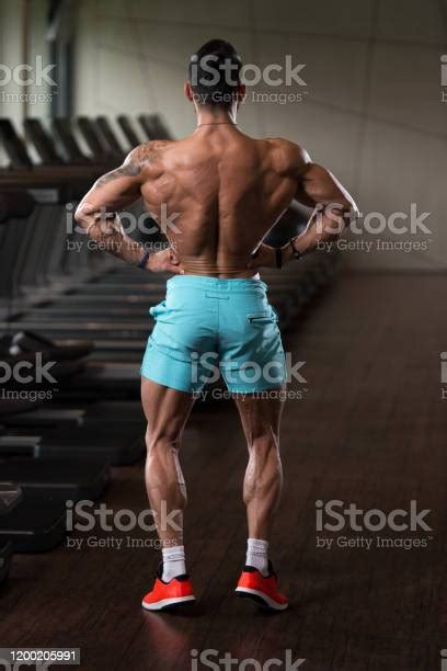 Muscular Man Flexing Back Muscles Pose Stock Photo Download Image Now