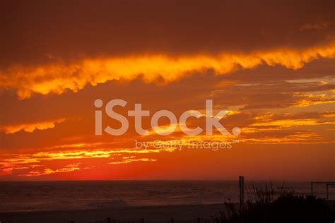 Fiery Sunset Over Ocean Stock Photos