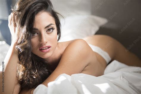 sexy woman lying down on the bed foto de stock adobe stock