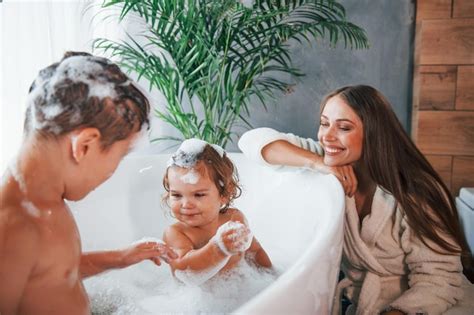 Premium Photo Having Fun Young Mother Helps Her Son And Daughter Two