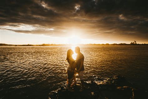 Loving Couple At Seaside At Sunset · Free Stock Photo