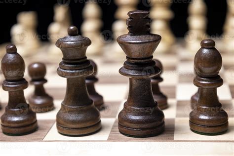 A Chess Board Asnd Pieces Against Black Background Stock Photo