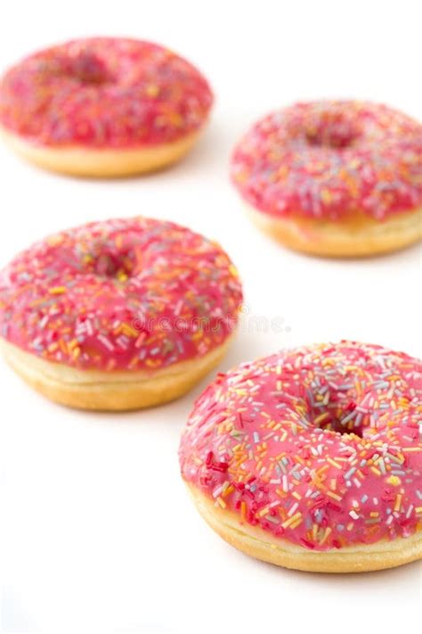 Pink Frosted Donut With Colorful Sprinkles On Yellow Background Stock