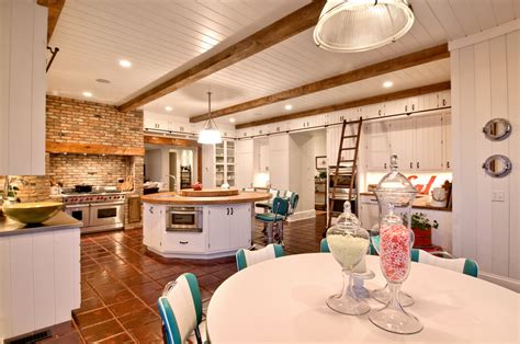 The new island has a hickory base that coordinates with the beam and refinished floors. Retro Rustic Kitchen - Hamptons Habitat