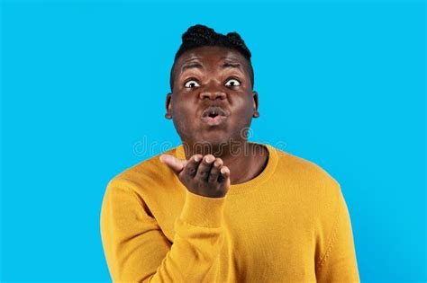 Young African American Man Pouting Lips And Blowing Air Kiss At Camera Stock Image Image Of