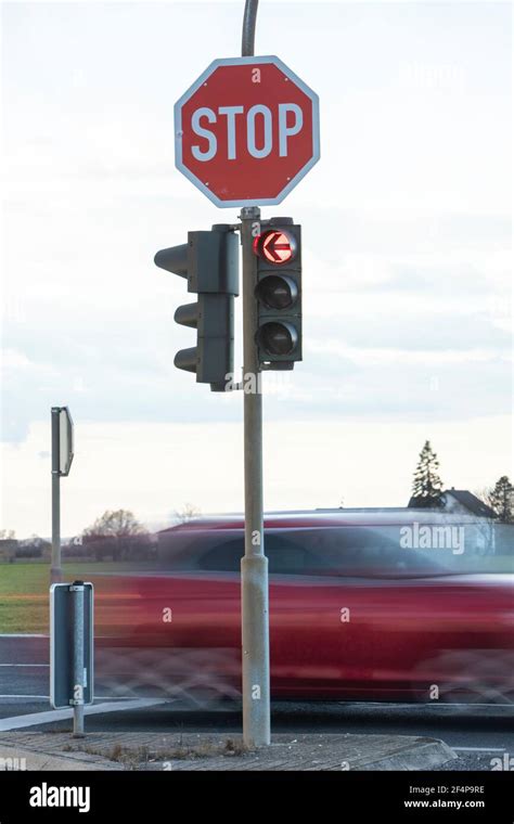 German Stop Sign And A Traffic Light Showing Red Arrow To The Left