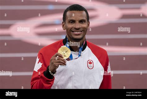 Canada‚Äôs Andre De Grasse From Markham Ont Holds Up The Gold Medal During A Ceremony For The