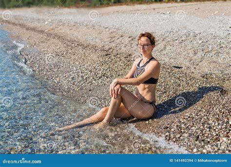 Summer Vacation Concept Woman Sitting On The Beach And Looking At The Sea Stock Photo Image