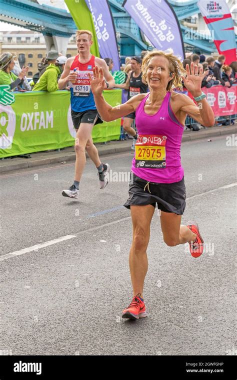 Runners Completing The 41st London Marathon Running Over Tower Bridge