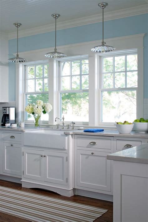 Home » kitchen » 21 light blue kitchen design and decor ideas to make your kitchen a happy place. Glass pendant lighting, white farm sink, kitchen windows ...