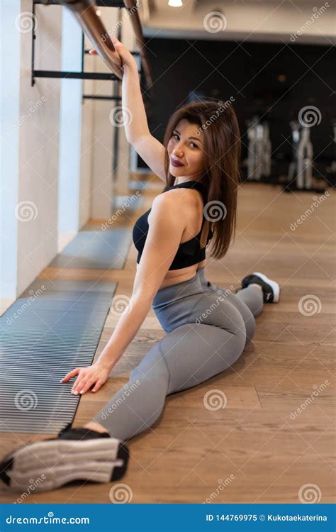 Young Woman Doing Stretching Exercises In Gym Stock Image Image Of